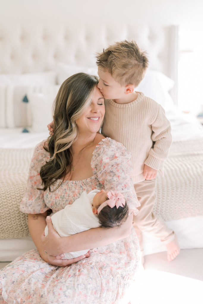 Winston Salem Newborn Photographers toddler kisses mom during newborn session