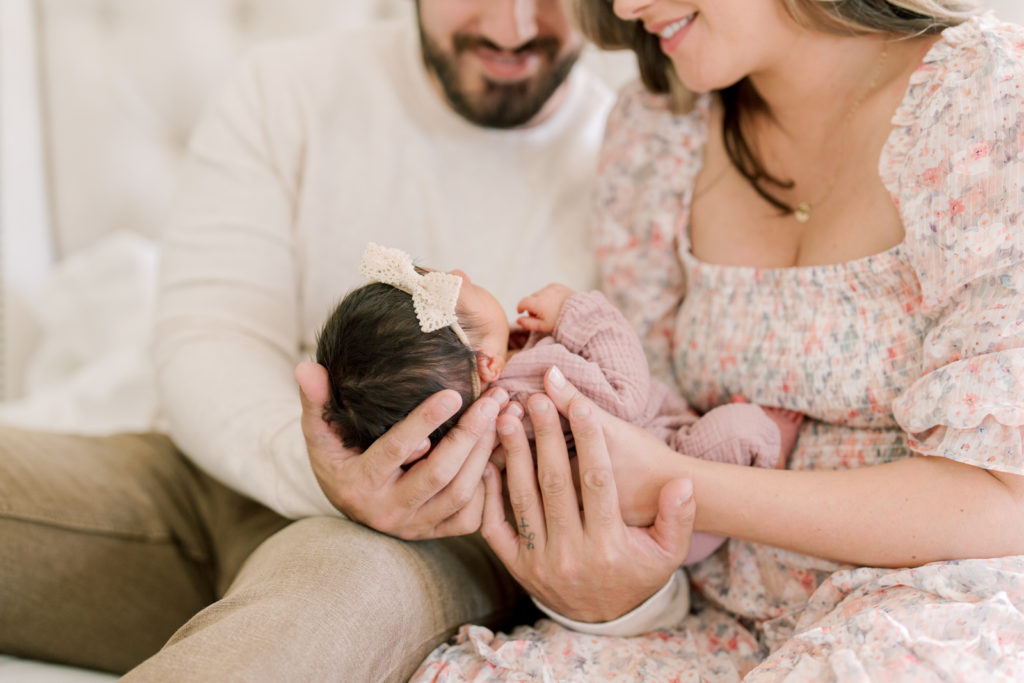 Winston Salem Newborn Photographers newborn held by mother and father