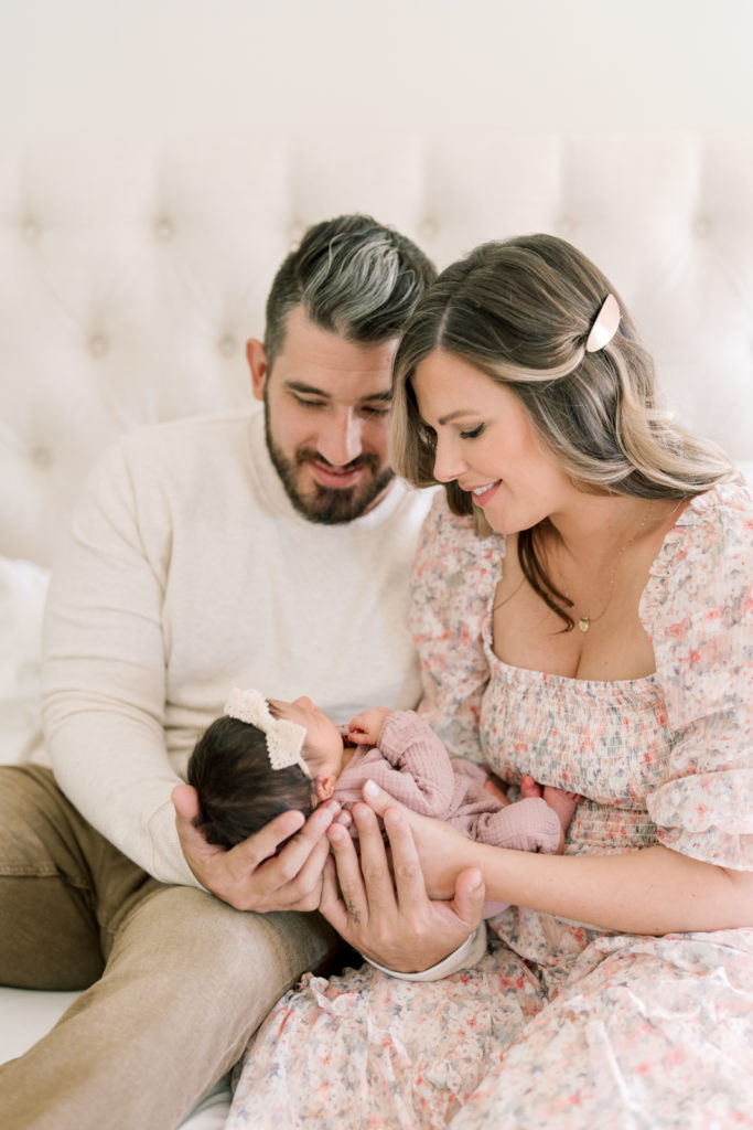 Winston Salem Newborn Photographers mom and dad snuggle newborn