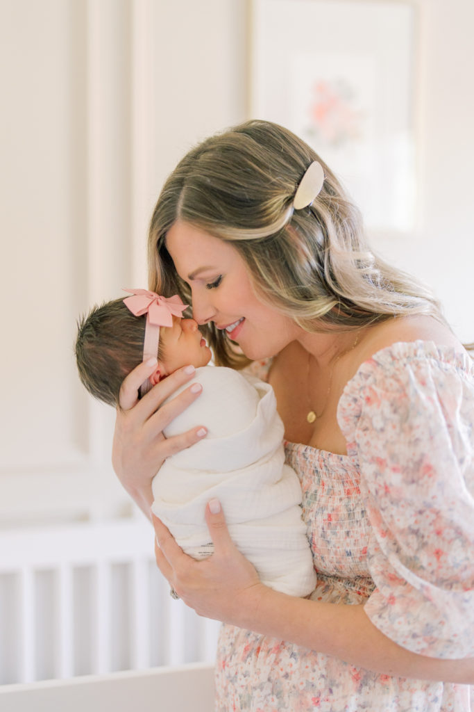 Winston Salem Newborn Photographers Mom nuzzling baby during newborn session
